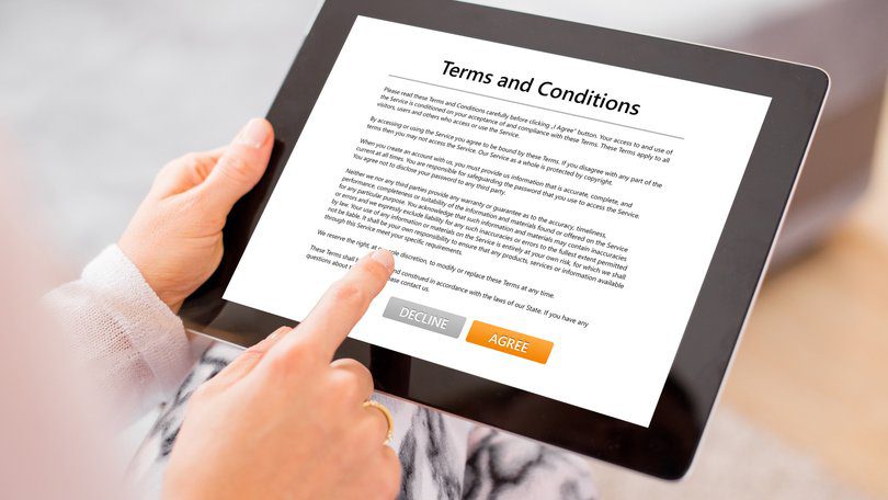 Person using a tablet to read and sign the Terms and Conditions of an online service.
